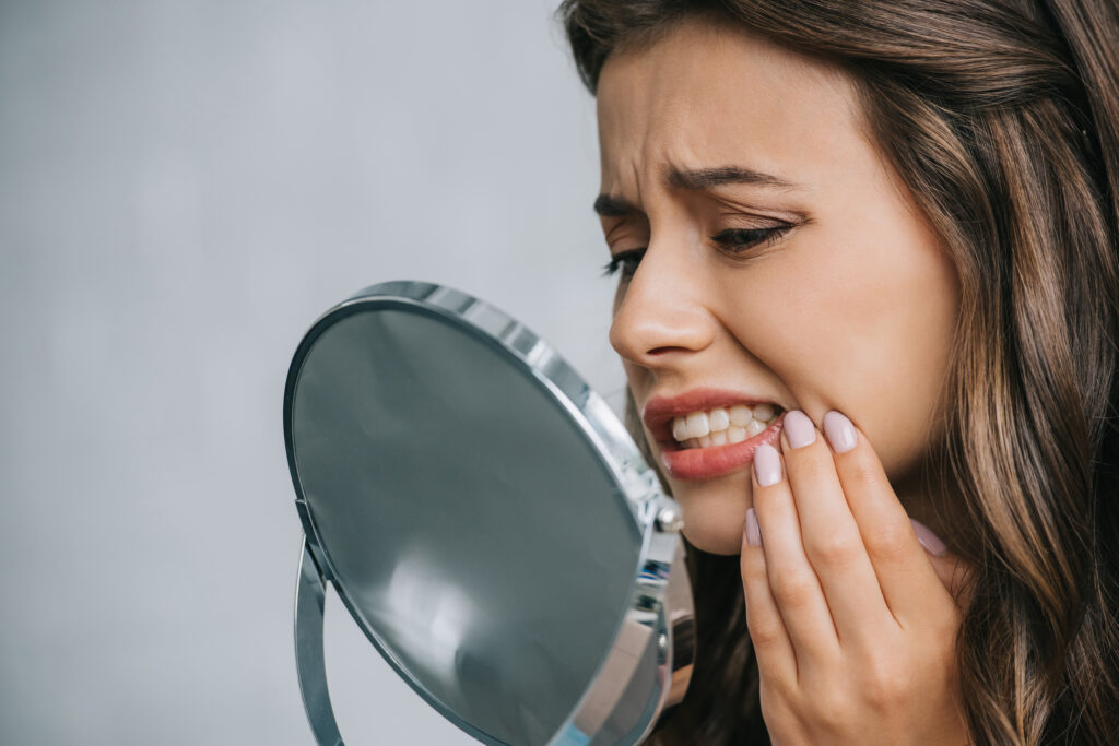 What Color Are Teeth Naturally? Close-up view of young woman having toothache.
What Color Are Teeth Naturally?