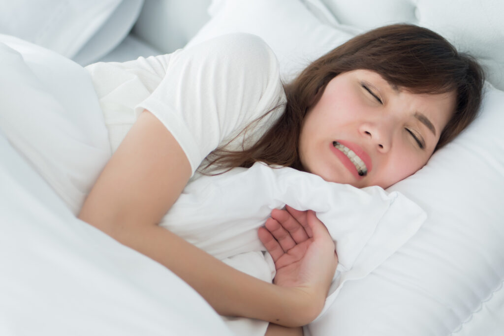 The Issues Of Mouth Breathing And Teeth stressed woman with grinding teeth, bruxism symptoms; portrait of stressful, exhausted, tired sleeping woman grinding her teeth with stress; oral, dental care medical concept; asian adult woman model. Issues of Mouth Breathing